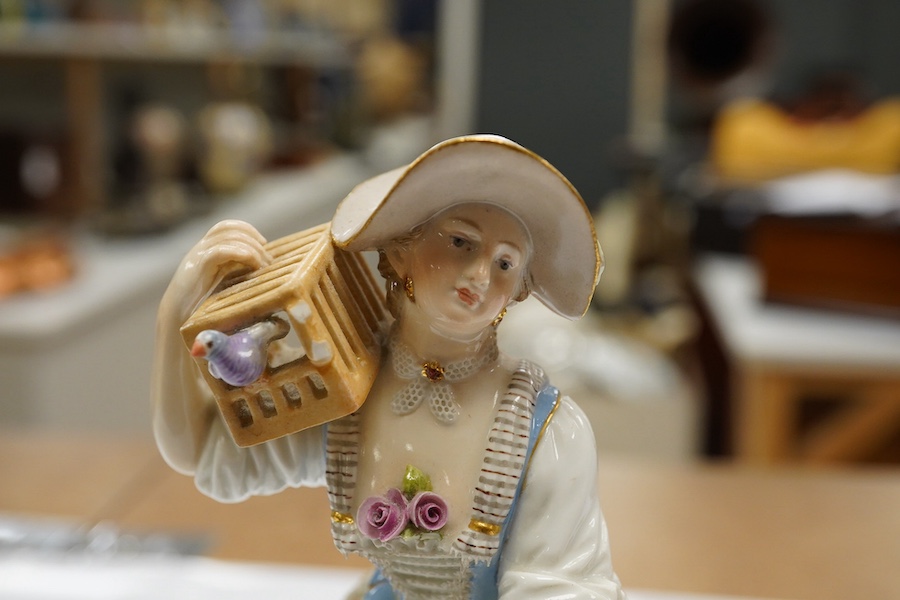 A 19th century Meissen figure of a shepherdess with a birdcage, incised F73, 18cm. Condition - fair